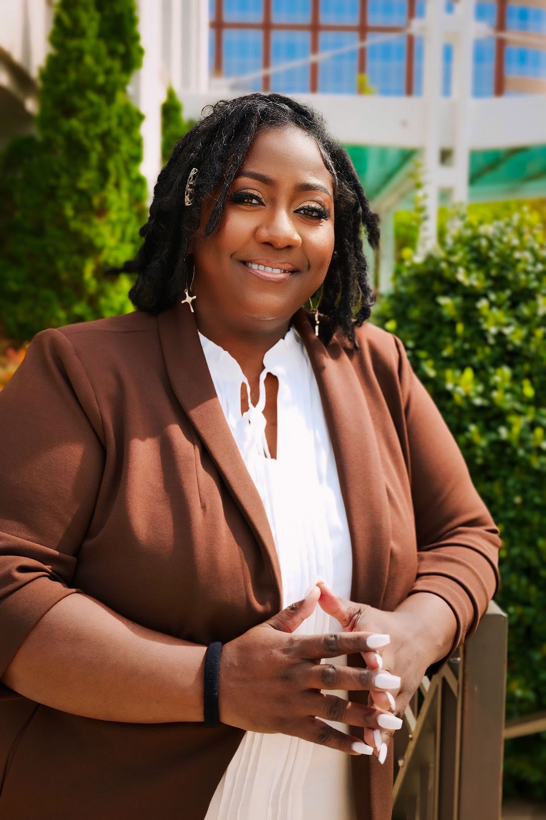 Rose Sherrod, AI Product Manager, smiling in a brown blazer outdoors.